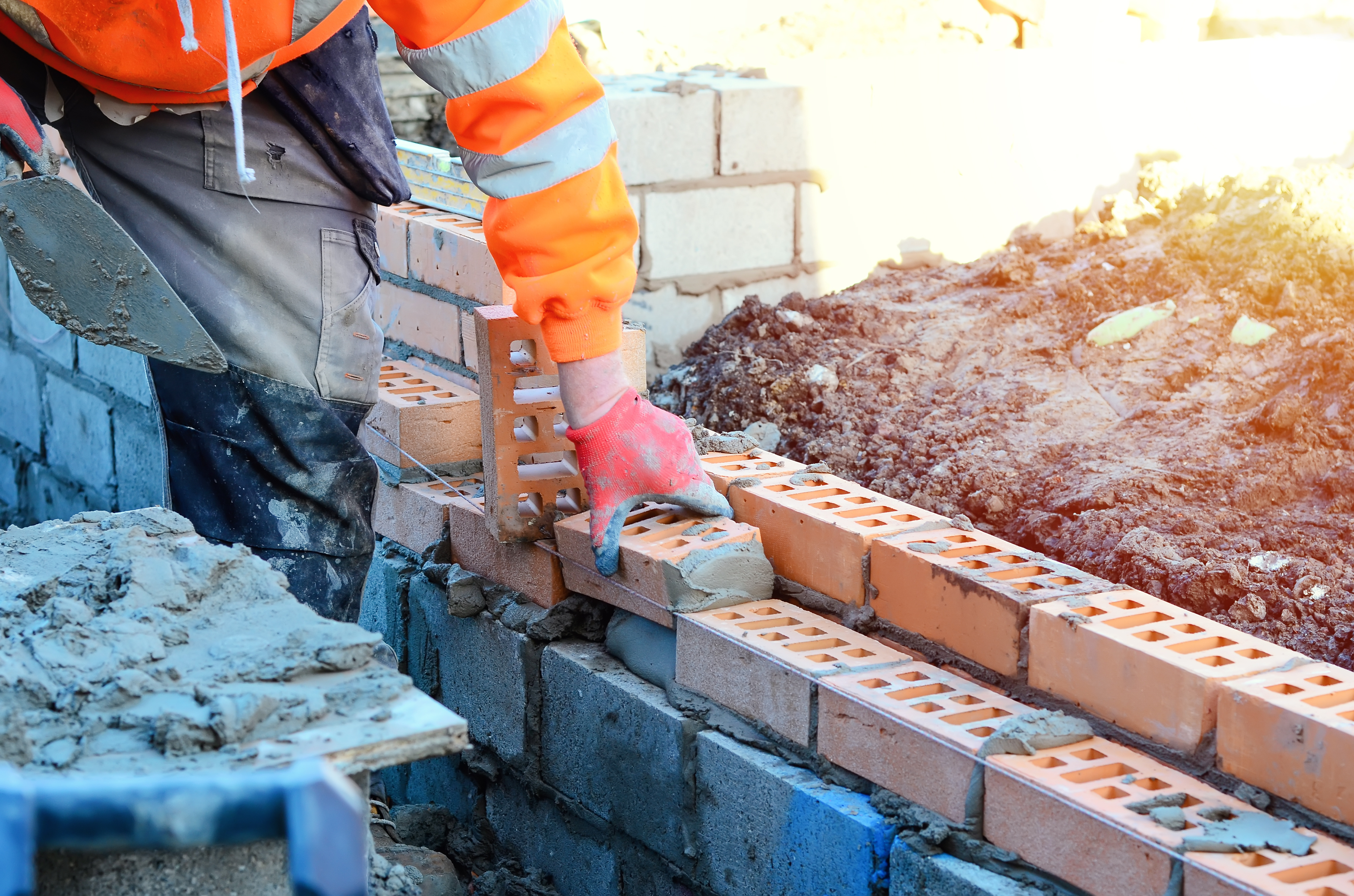 A man bricklaying a wall